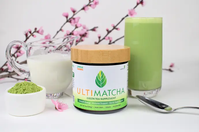 A jar of Ultimatcha with a prepared matcha latte in a glass